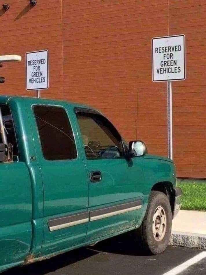 pic-of-a-green-truck-parked-in-front-of-a-sign-that-reads-reserved-for-green-vehicles